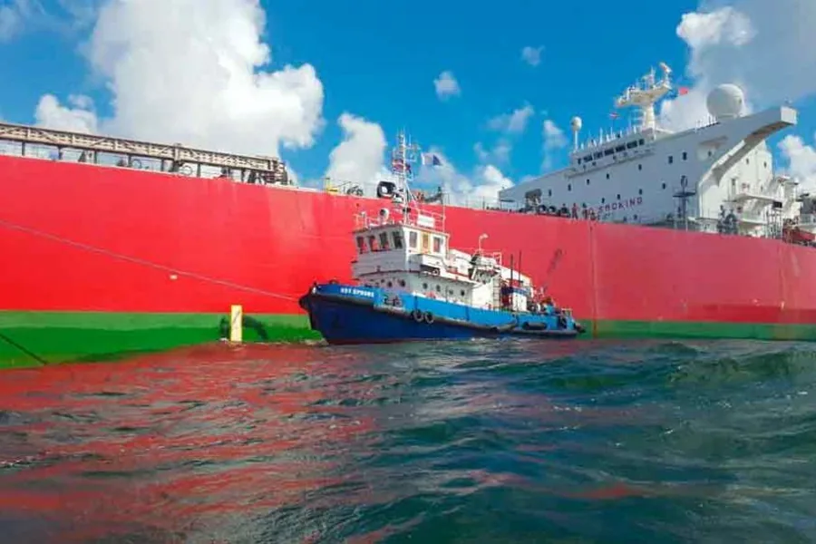 Tug supporting a vessel